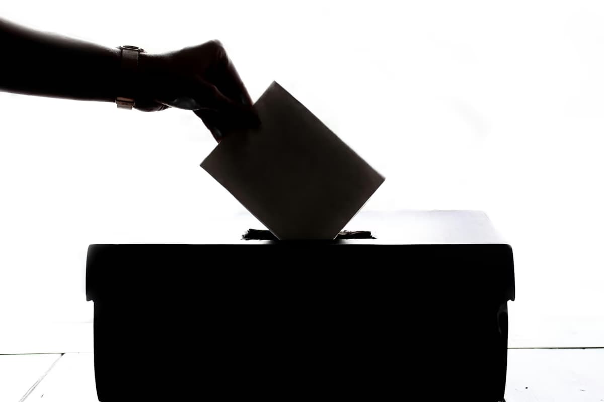 Voter casting ballot in democratic election
